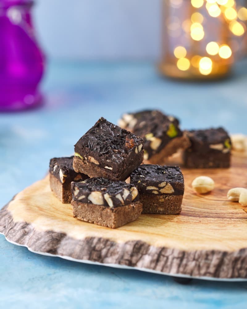 Chocolate-nut barfi on a wood slice